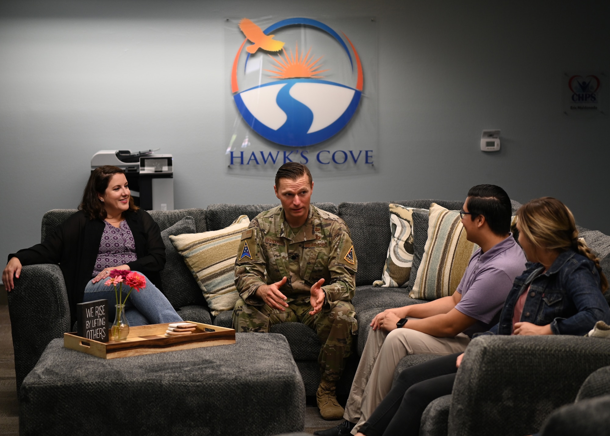 Lt. Col. Brandon Bernardoni, Space Launch Delta 30 integration lead, giving a morning brief to Emily Dreiling, Space Launch Delta 30 Diversity, Equity and Inclusion director, program manager and Co-Location Pilot Program assistant action officer, Eric Maladonado, Health Program Services civilian, Hailey Stowe, Health Program Services civilian coordinator. (U.S. Space Force photo by Airman 1st Class Tiarra Sibley)