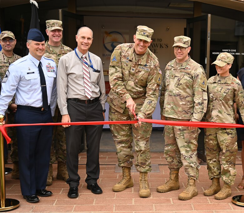 Col. Robert Long, Space Launch Delta 30 commander begins to cut the ribbon with members of Vandenberg at the Hawk’s Cove Integrated Resilience Operation Center grand opening at Vandenberg Space Force Base, Calif., Sept. 27, 2022. (U.S. Space Force photo by Airman 1st Class Tiarra Sibley)