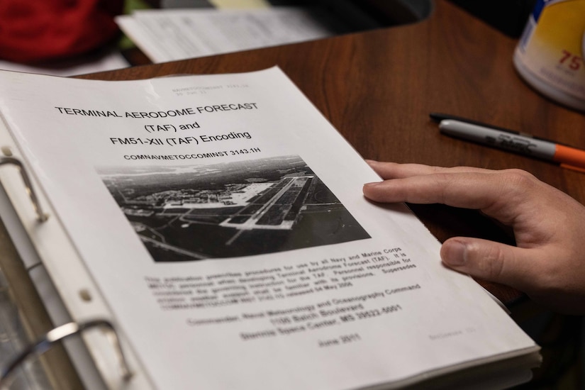 A large binder holds information about weather forecasting.