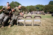 U.S. Marines with Fleet Marine Force, Atlantic (FMFLANT), Marine Forces Command (MARFORCOM), Marine Forces Northern Command (MARFOR NORTHCOM), and their respective Headquarters and Service Battalion (HQSVCBN), compete in musical chairs during a field meet at Naval Support Activity Hampton Roads, Virginia, Sept. 22, 2022. Marines with FMFLANT, MARFORCOM, MARFOR NORTHCOM, and their respective HQSVCBN, competed in a dessert bake off, polyvinyl chloride pipe construction contest, musical chairs, football throwing competition and tug-of-war in order to win the unit trophy. FMFLANT, MARFORCOM, MARFOR NORTHCOM, and their respective HQSVCBN, hold quarterly field meets to sustain camaraderie and boost morale within the unit through friendly competitions. (U.S. Marine Corps photo by Lance Cpl. Jack Chen)