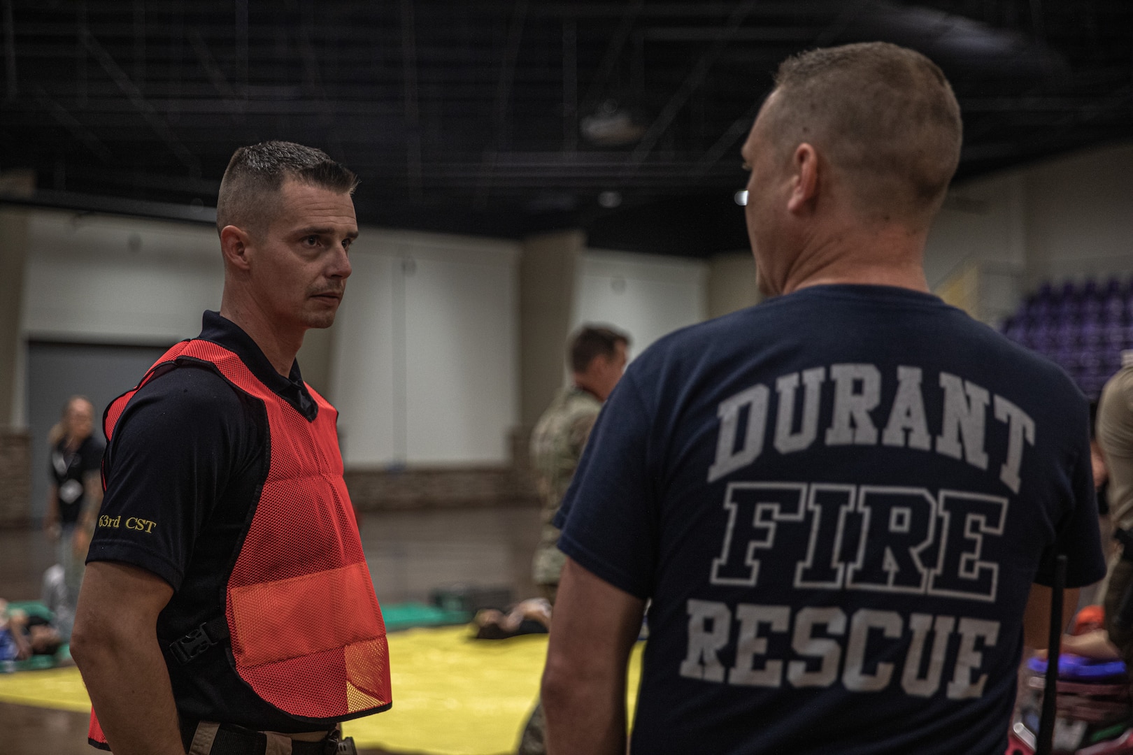 Sgt. 1st Class Ron Poland (left), medical non-commissioned officer, 63rd Civil Support Team, 90th Troop Command, Oklahoma Army National Guard, speaks with a member of the Durant Fire Department during a Regional Emergency Medical Services System training event at the Choctaw Event Center in Durant, Oklahoma, September 21, 2022. (Oklahoma National Guard Photo by Sgt. Reece Heck)