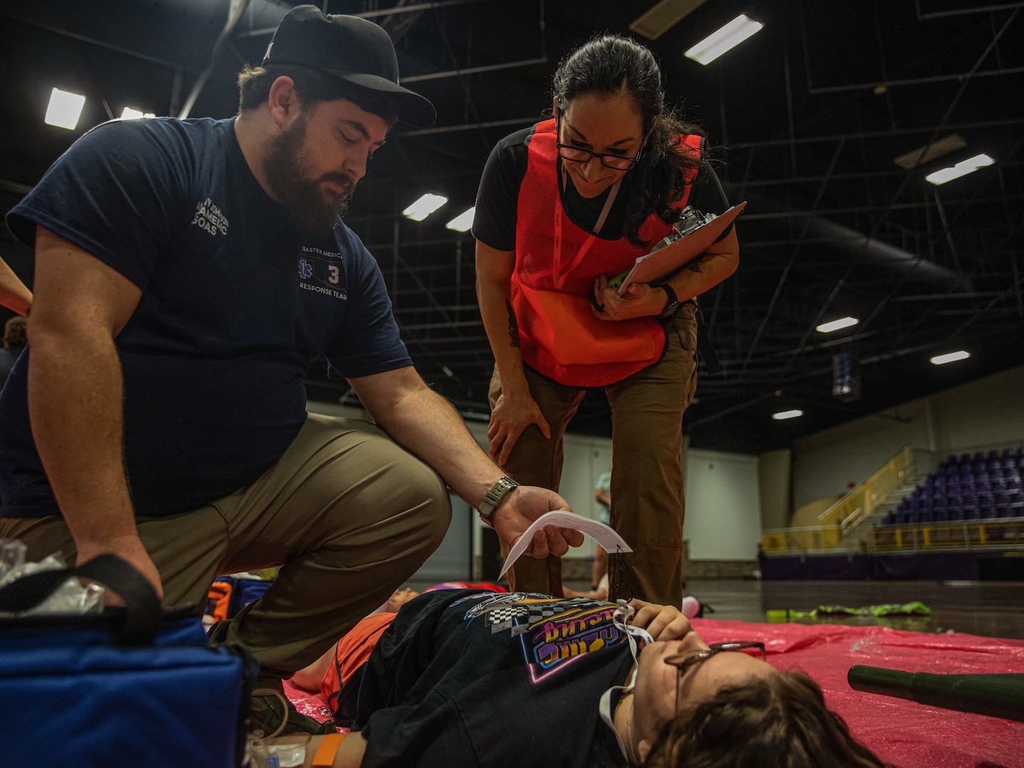 Capt. Vanessa Weaver (right), deputy state surgeon for the Oklahoma Army National Guard, assists an emergency medical technician during a Regional Emergency Medical Services System training event at the Choctaw Event Center in Durant, Oklahoma, September 21, 2022.  A total of around 170 first responders participated in this annual training event. (Oklahoma National Guard Photo by Sgt. Reece Heck)