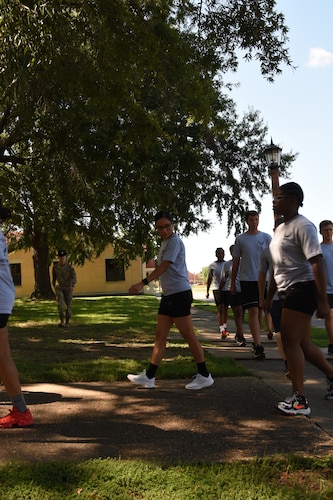 a military training instructor marches new recruits