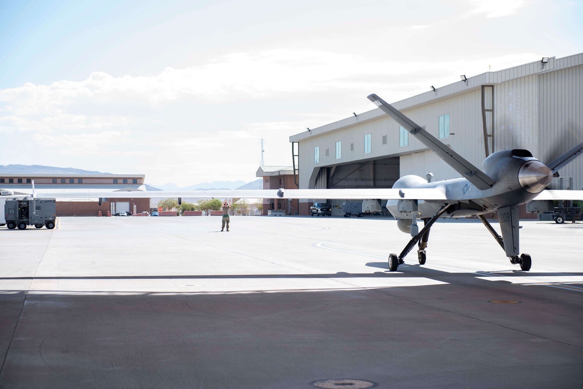 An Operational Test MQ-9 Reaper prepares for first-time Portable Aircraft Control Station launch on July. 12, 2022, at Creech Air Force Base, Nevada. When fielded and fully mission capable, PACS will eliminate the requirement for a downrange LR cockpit and flight crew for MQ-9 deployment, increasing the agility of the MQ-9. (U.S. Air Force photo by Mr. Robert Brooks)