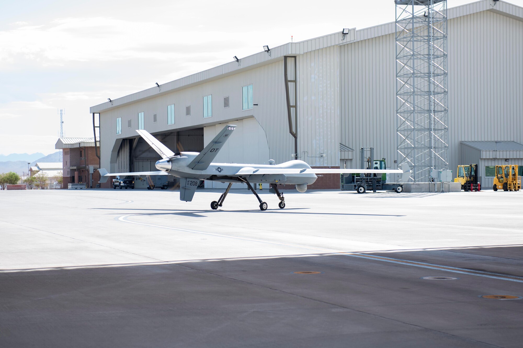 An Operational Test MQ-9 Reaper prepares for a first-time Portable Aircraft Control Station launch on July. 12, 2022, at Creech Air Force Base, Nevada. When fielded and fully mission capable, PACS will eliminate the requirement for a downrange LR cockpit and flight crew for MQ-9 deployment, increasing the agility of the MQ-9. (U.S. Air Force photo by Mr. Robert Brooks)