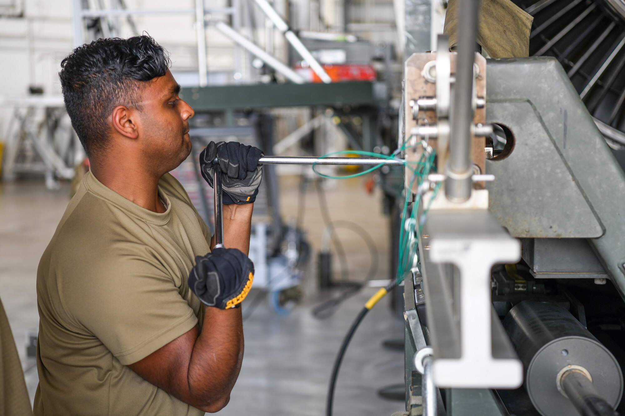 Senior Airman Troy Bassant, 445th Aircraft Maintenance Squadron propulsion journeyman, makes adjustments to an engine cradle during an engine swap on a C-17 Globemaster III at WPAFB Sept. 13, 2022. 445th Airlift Wing maintainers were key players for the eight launches a day, executed three days in a row, for a total of 24 launches for Operation Merciful Valkyrie on top of other real-world missions the wing was supporting at the same time.