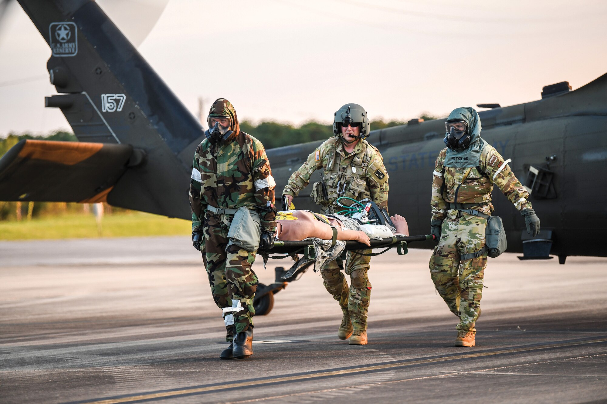 (from left to right) Second Lt. Kiley Gerritsen), 445th Aeromedical Staging Squadron critical care air transport team member, Army Spc. Scott Hillman, 159th Regiment General Support Aviation Battalion flight medic, Fort Knox, and Staff Sgt. Trey Naber, 445th Aeromedical Evacuation Squadron AE technician, carry a litter from an HH-60 Pave Hawk helicopter on a Fort Campbell, Kentucky flightline, Sept. 13, 2022.