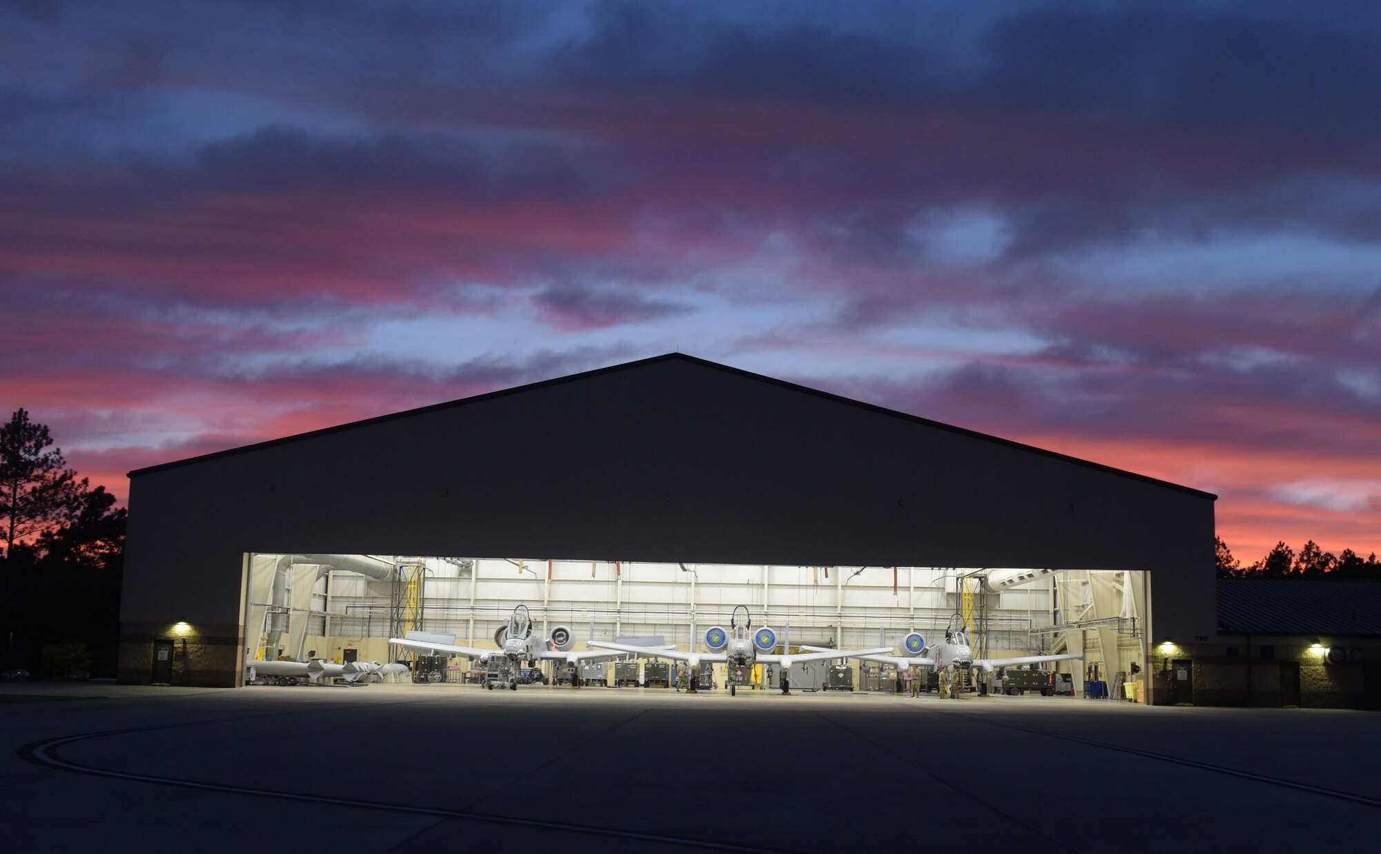 Photo of hangar with three aircraft inside