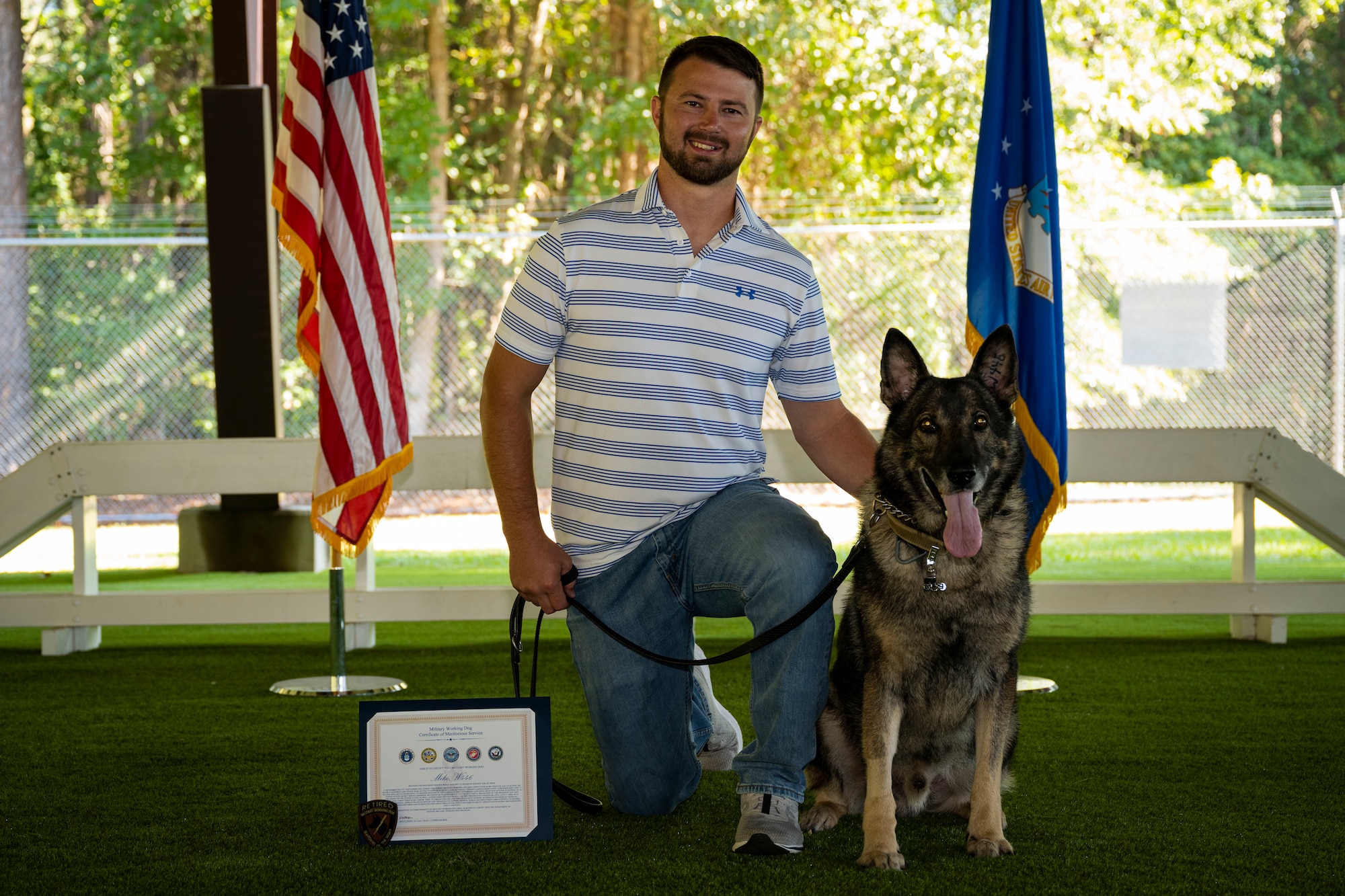 Military Working Dog Miko and Nick Armstrong, Miko’s former handler, pose for a photo at Seymour Johnson Air Force Base, North Carolina, Sept. 26, 2022. MWD Miko served seven years at the 4th Security Forces Squadron. (U.S. Air Force photo by Senior Airman David Lynn)