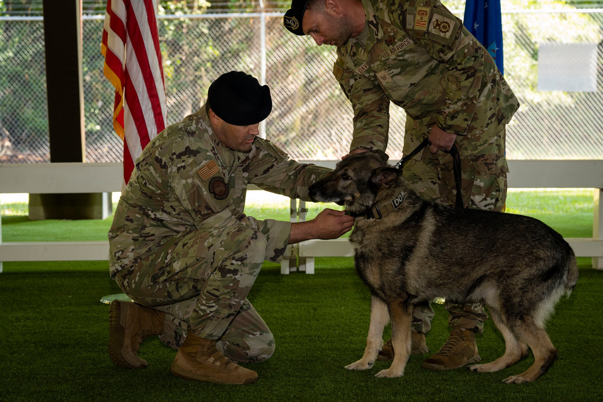 Lt. Col. Michael Wetlesen, 4th Security Forces Squadron commander, pins a retirement medal on Military Working Dog Miko during a retirement ceremony at Seymour Johnson Air Force Base, North Carolina, Sept. 26, 2022. Miko arrived at Seymour Johnson AFB in 2015. (U.S. Air Force photo by Senior Airman David Lynn)