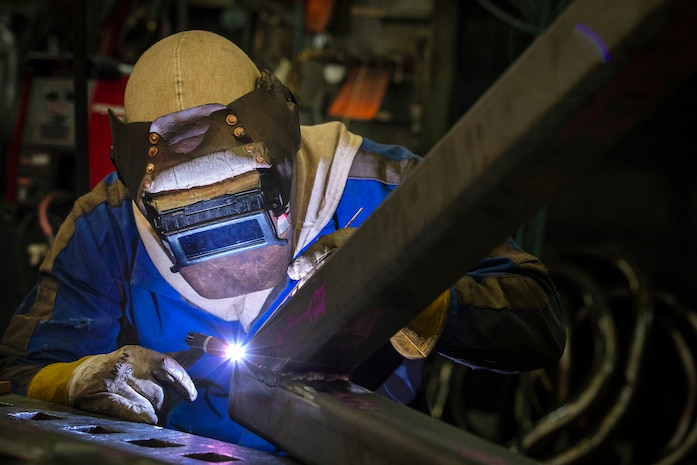 Peter Echols, welder-mechanic, Shop 26, works on a new stainless steel stand for the Bicentennial Log Jan. 25, 2022, at Puget Sound Naval Shipyard & Intermediate Maintenance Facility in Bremerton, Washington. (U.S. Navy photo by Scott Hansen)