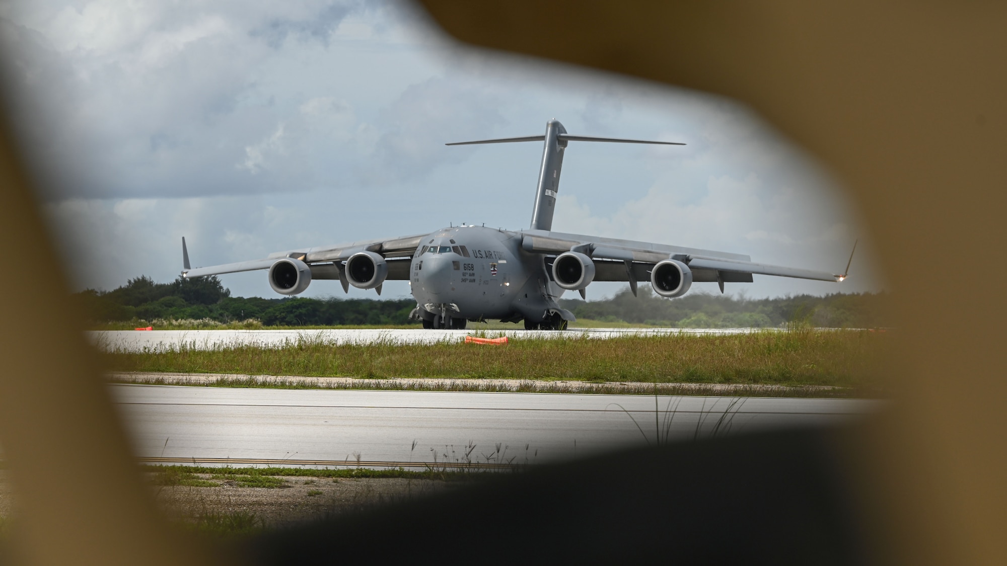 A U.S. Air Force C-17 Globemaster III assigned to Travis Air Force Base, California, lands on Northwest Field during Exercise GOLDEN BEE at Andersen Air Force Base, Guam, Sept. 26, 2022. Exercise GOLDEN BEE is a joint readiness exercise designed to provide training integration and rehearse strategic and operational objectives in support of Agile Combat Employment initiatives in the Indo-Pacific area of responsibility. (U.S. Air Force photo by Staff Sgt. Aubree Owens)
