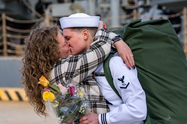 NORFOLK (Sept. 28, 2022) A Sailor, assigned to the Arleigh Burke-class destroyer USS Gonzalez (DDG 66), embraces their partner upon returning to Naval Station Norfolk after a regularly scheduled deployment in the U.S. 5th Fleet and U.S. 6th Fleet areas of operations, Sept. 28. Gonzelez  was deployed as part of the Harry S. Truman Carrier Strike Group in support of theater security cooperation efforts and to defend U.S., allied and partner interests. (U.S. Navy photo by Mass Communication Specialist 2nd Class Nathan T. Beard)
