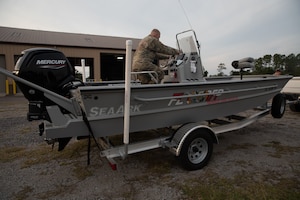 Florida National Guard Army Pfc. Kenneth Bonn, a combat engineer with the 753rd Engineering Brigade, inspects a search and rescue vessel during Hurricane Ian state activation, Camp Blanding Joint Training Center, Fla., Sept. 27, 2022. Bonn is part of the Florida National Guard's Chemical, Biological, Radiological/Nuclear, and Explosive (CBRNE) - Enhanced Response Force Package (FL-CERFP).