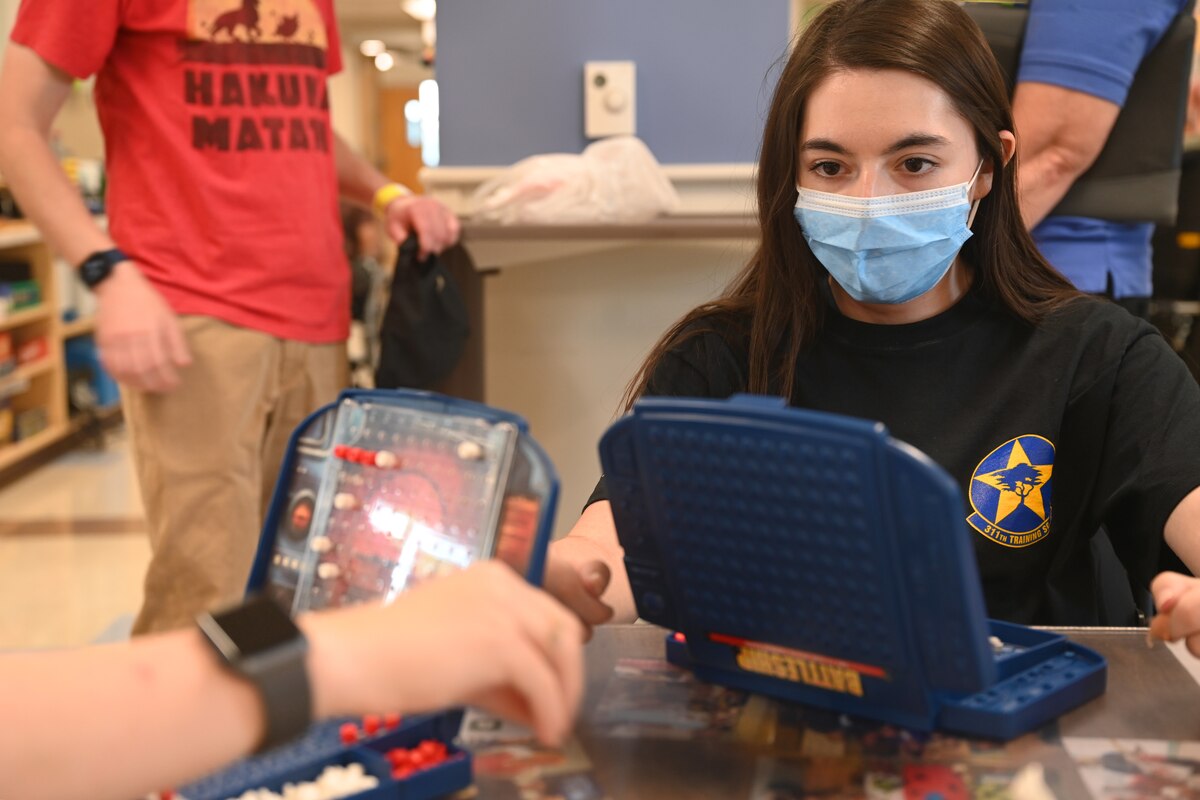 U.S. Air Force Airman 1st Class Lauren Arduser, 311th Training Squadron Russian language analyst, strategizes her next move during her occupational therapy session at the St. Louis VA Healthcare System-Jefferson Barracks, Missouri, August 17, 2022. Arduser’s four limbs were originally determined as paralyzed, but through personal resilience, Arduser has made significant improvements and can move every limb. (U.S. Air Force photo by Senior Airman Abbey Rieves)