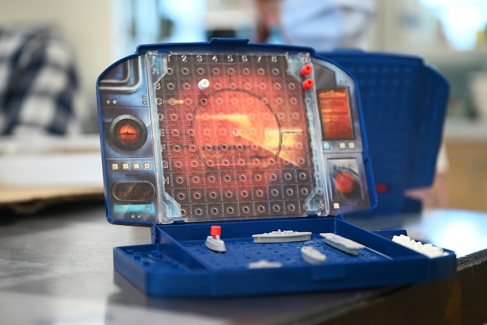 The game Battleship sits on a table during U.S. Air Force Airman 1st Class Lauren Arduser, 311th Training Squadron Russian language analyst, occupational therapy session at the St. Louis VA Healthcare System-Jefferson Barracks, Missouri, August 17, 2022. Battleship is a game designed for strategy development; the object is to guess where the opponent’s fleet is located. The game’s tiny game pieces were used to develop Arduser’s finger movement skills. (U.S. Air Force photo by Senior Airman Abbey Rieves)