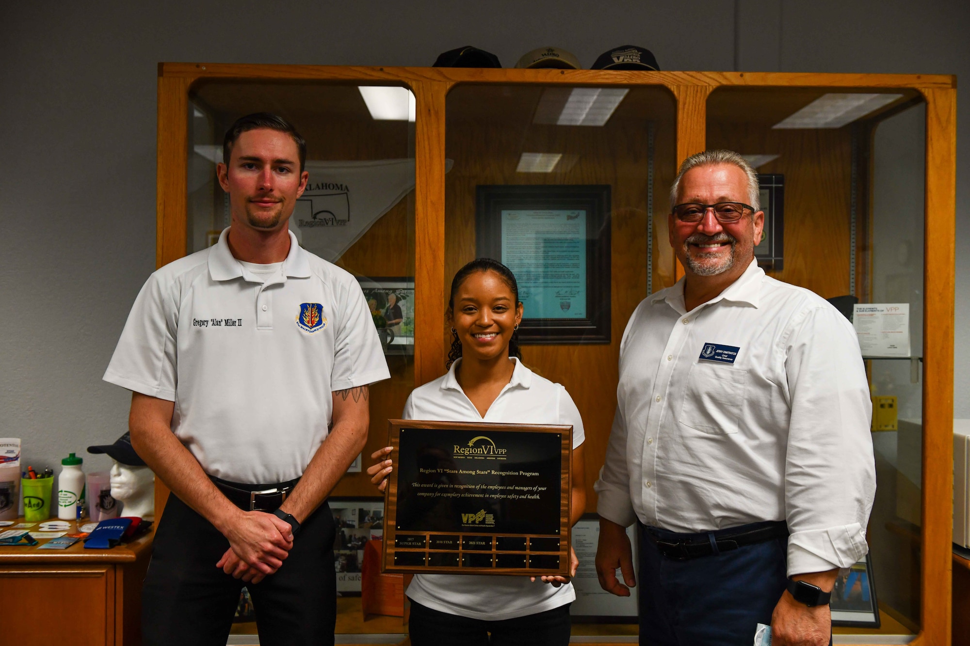 From left, Gregory Miller, Tyra Jones, and Jerry Dimitratos, members of the 97th Maintenance Group (MXG) Voluntary Protection Program team, show off the Star Among Stars award at Altus Air Force Base, Oklahoma, September 13, 2022. The 97th Air Mobility Wing MXG previously won the award in 2015, 2016, 2017, and 2018. (U.S. Air Force photo by Airman 1st Class Kari Degraffenreed)
