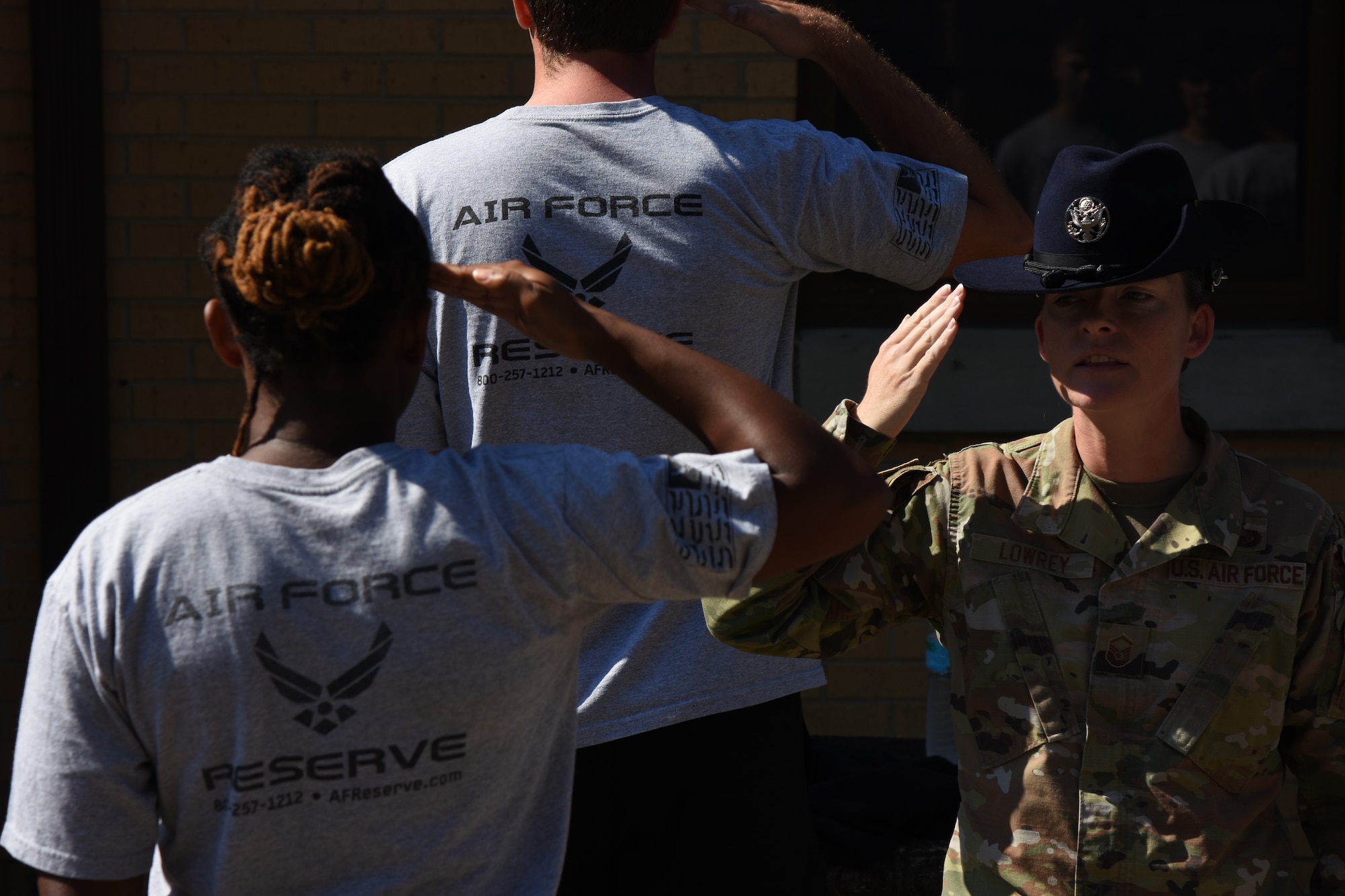 a military training instructor teaches recruits how to properly salute