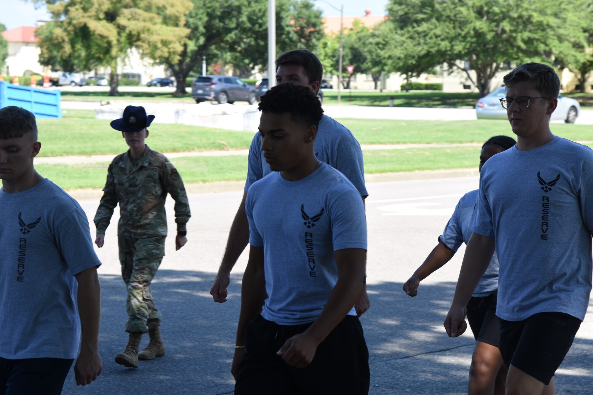 a military training instructor marches new recruits