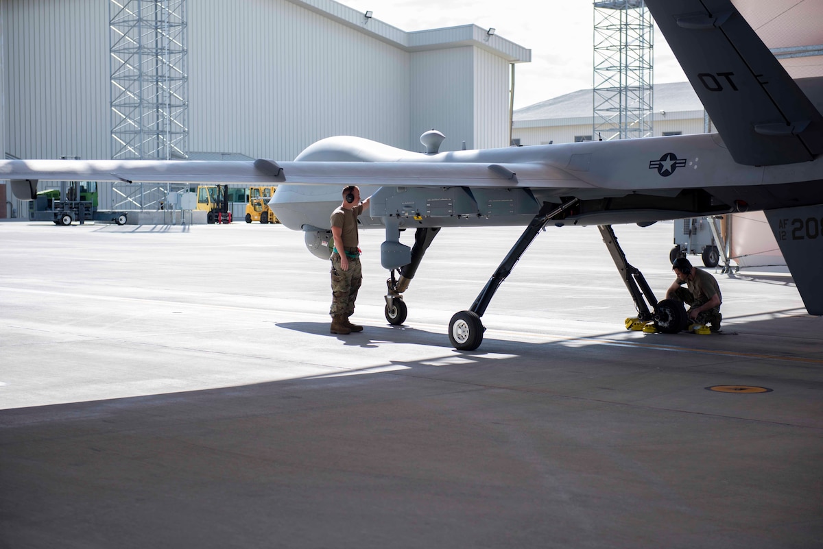 An Airman from the 432d Aircraft Maintenance Squadron prepares an Operational Test MQ-9 Reaper as part of a first-time Portable Aircraft Control Station launch on July. 12, 2022, at Creech Air Force Base, Nevada. When fielded and fully mission capable, PACS has the potential to replace the Ruggedized Aircraft Maintenance Test Stand. (U.S. Air Force photo by Mr. Robert Brooks)