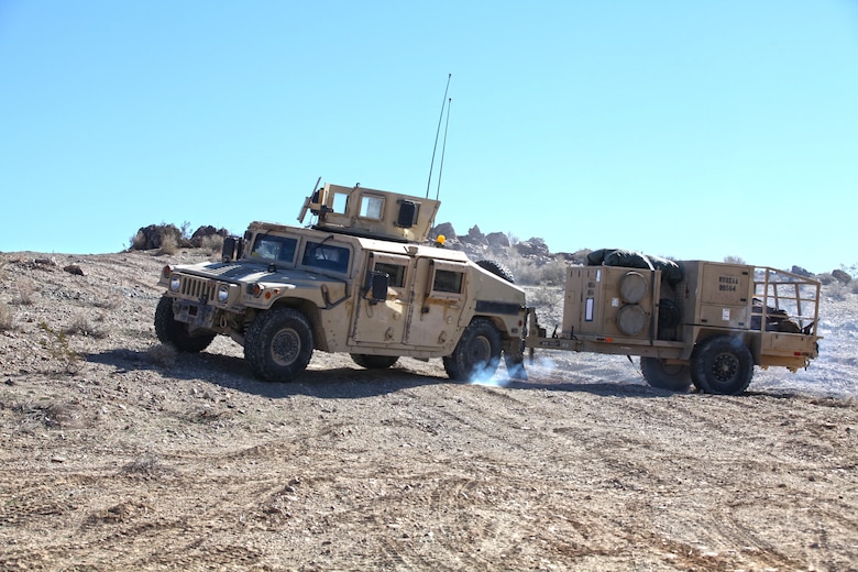 A utility vehicle tows a trailer up a hill.