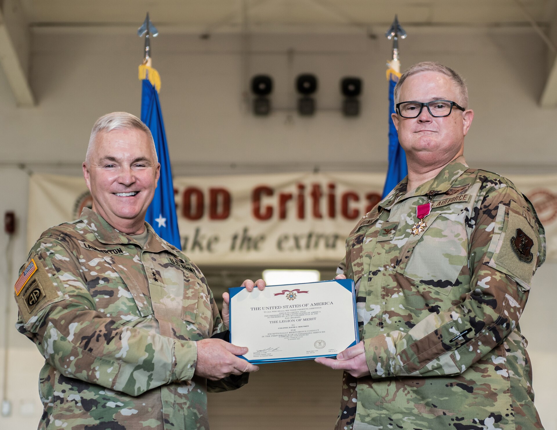 Maj. Gen. Haldane B. Lamberton, left, adjutant general of the Commonwealth of Kentucky, awards the Legion of Merit to Col. David J. Mounkes, assistant adjutant general for Air, during Mounkes’ promotion ceremony at the Kentucky Air National Guard Base in Louisville, Ky., Aug., 13, 2022. Mounkes also assumed command of the Kentucky Air Guard during the event, taking on the role of assistant adjutant general for Air from Brig. Gen. Jeffrey L. Wilkinson, who is retiring. (U.S. Air National Guard photo by Staff Sgt. Chloe Ochs)