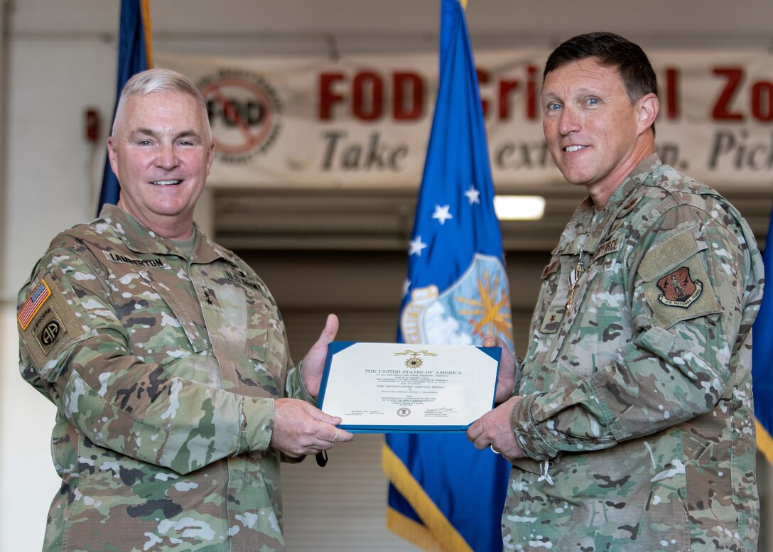Maj. Gen. Haldane B. Lamberton, left, adjutant general of the Commonwealth of Kentucky, awards the Distinguished Service Medal to Brig. Gen. Jeffrey L. Wilkinson, outgoing assistant adjutant general for Air, during a retirement ceremony at the Kentucky Air National Guard Base in Louisville, Ky., Aug. 13, 2022. A career special tactics officer, Wilkinson served the Air Force and Air National Guard for more than 28 years. (U.S. Air National Guard photo by Staff Sgt. Chloe Ochs)