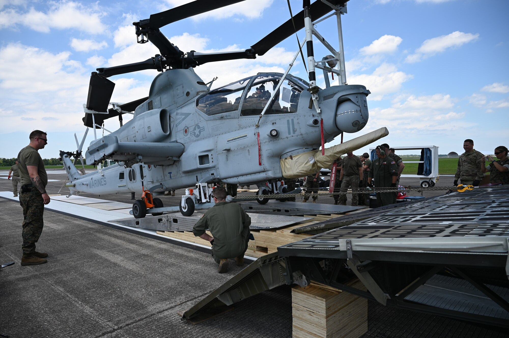 Reserve Citizen Airmen with the 68th Airlift Squadron and Marines with the Marine Light Attack Helicopter Squadron – 773, Det. Alpha guide a Bell AH-1Z Viper helicopter onto a C-5M Super Galaxy aircraft at Naval Air Station Joint Reserve Base New Orleans, Louisiana, Sept. 13, 2022. This was the first time the Marines from the HMLA-733 participated in the NATO days air show. (U.S. Air Force photo by Staff Sgt. Monet Villacorte)