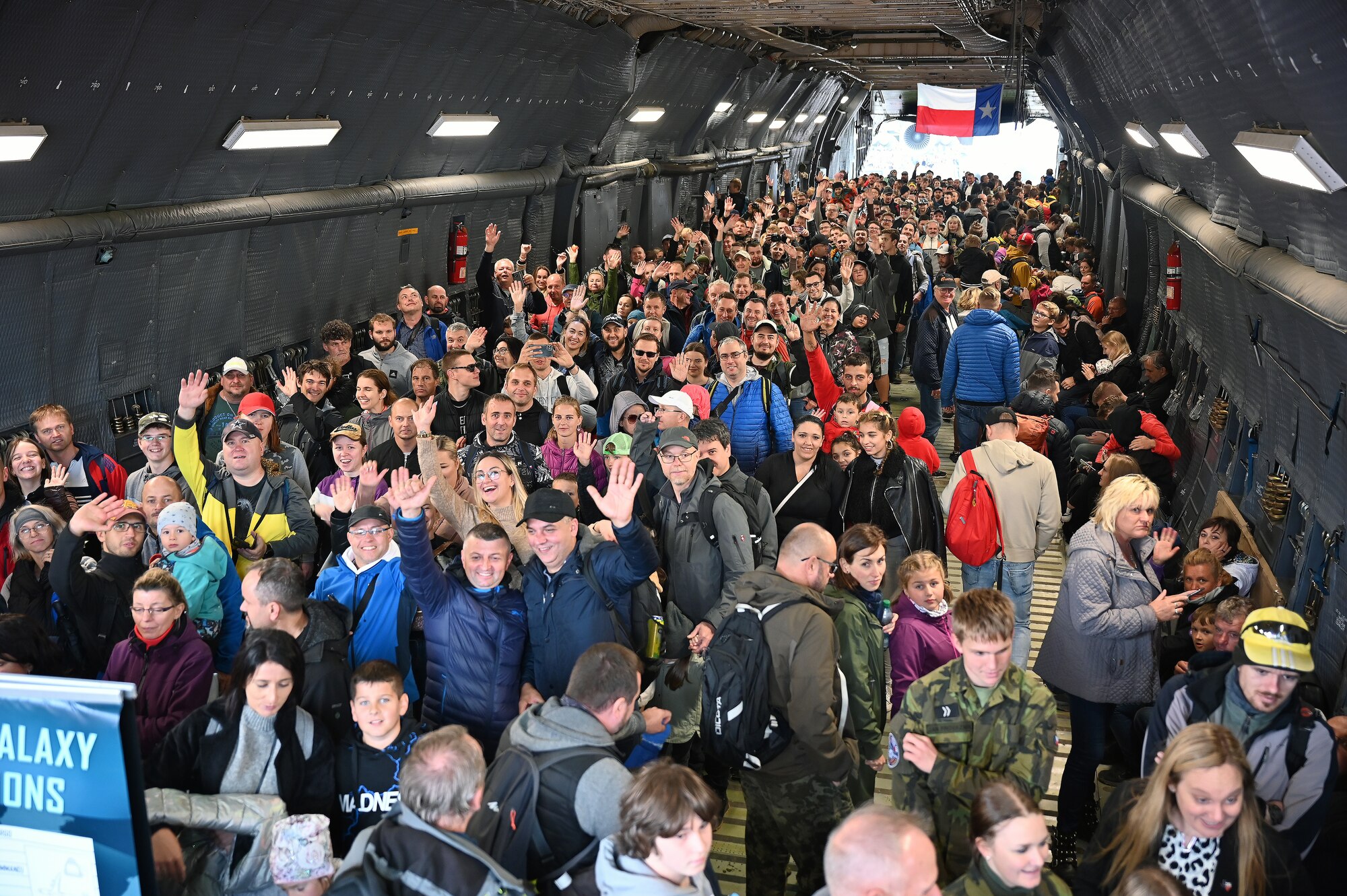 NATO Days air show participants smile and wave as they walk through a C-5M Super Galaxy aircraft in Ostrava, Czech Republic Sept. 17, 2022. The C-5M was the largest aircraft on display during the two-day event. (U.S. Air Force photo by Staff Sgt. Monet Villacorte)