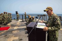 Cmdr. Sam Sareini, outgoing commanding officer of USS Nitze (DDG 94) gives remarks during a change of command ceremony in the Gulf of Aden, Sept. 28. Nitze is deployed to the U.S. 5th Fleet area of operations to help ensure maritime security and stability in the Middle East region.