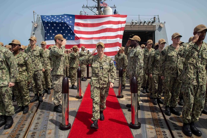 Sideboys salute Cmdr. Katie Jacobson during the change of command ceremony aboard the guided-missile destroyer USS Nitze (DDG 94) in the Gulf of Aden, Sept. 28. USS Nitze is deployed to the U.S. 5th Fleet area of operations to help ensure maritime security and stability in the Middle East region.