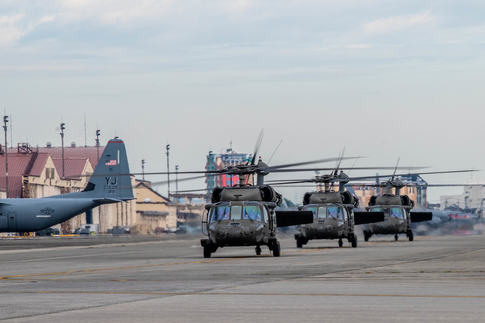 UH-60 Black Hawk helicopters taxi down a flightline