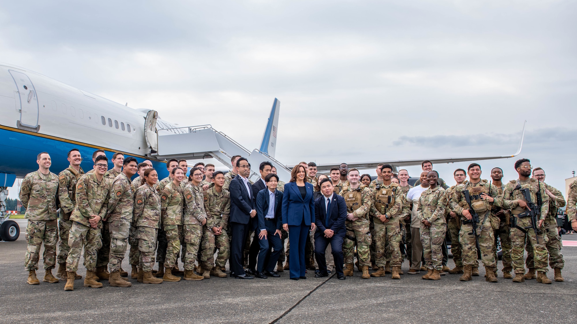 Vice President Harris poses for a group photo with troops