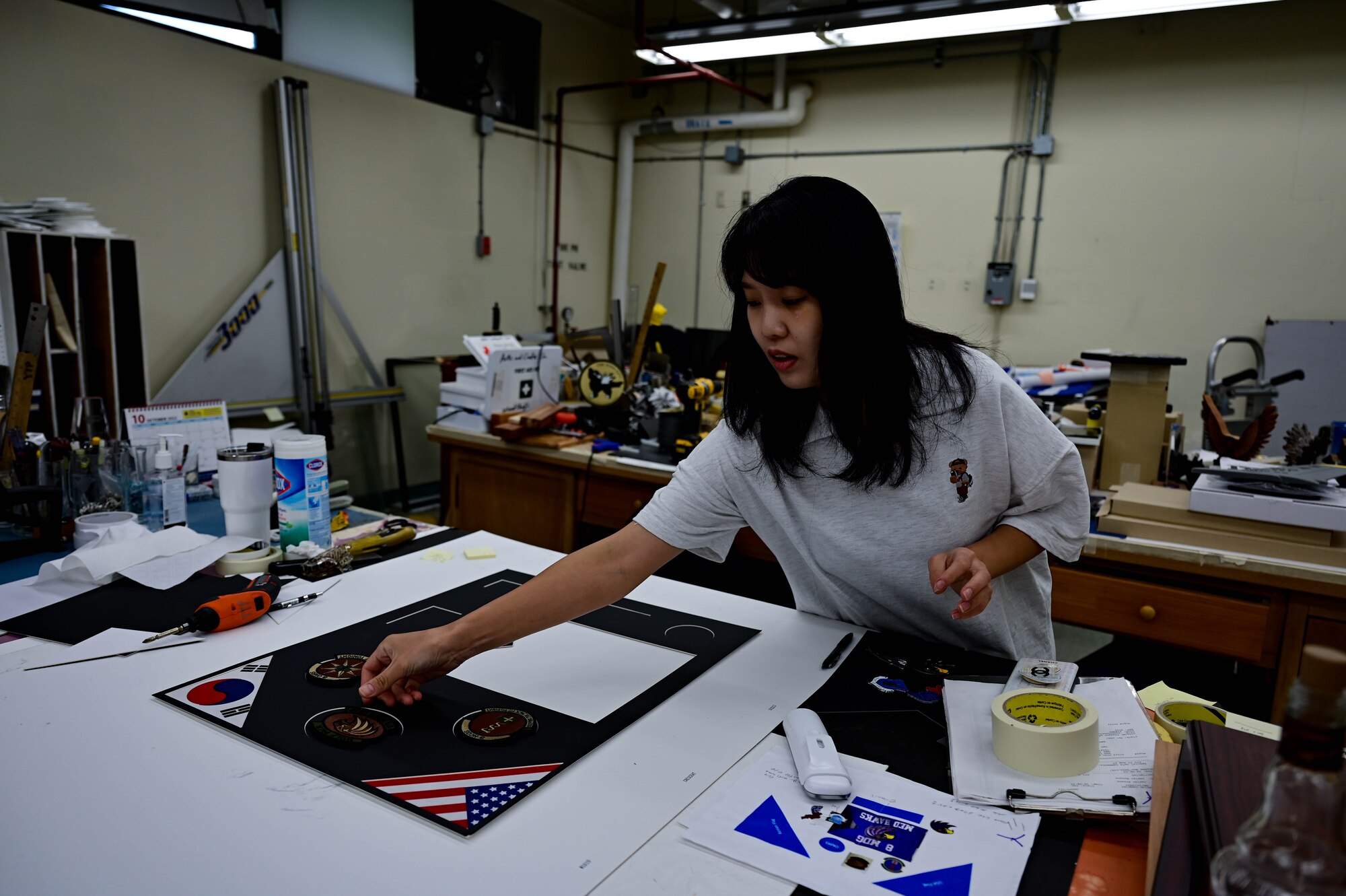 Woman places items on a table.