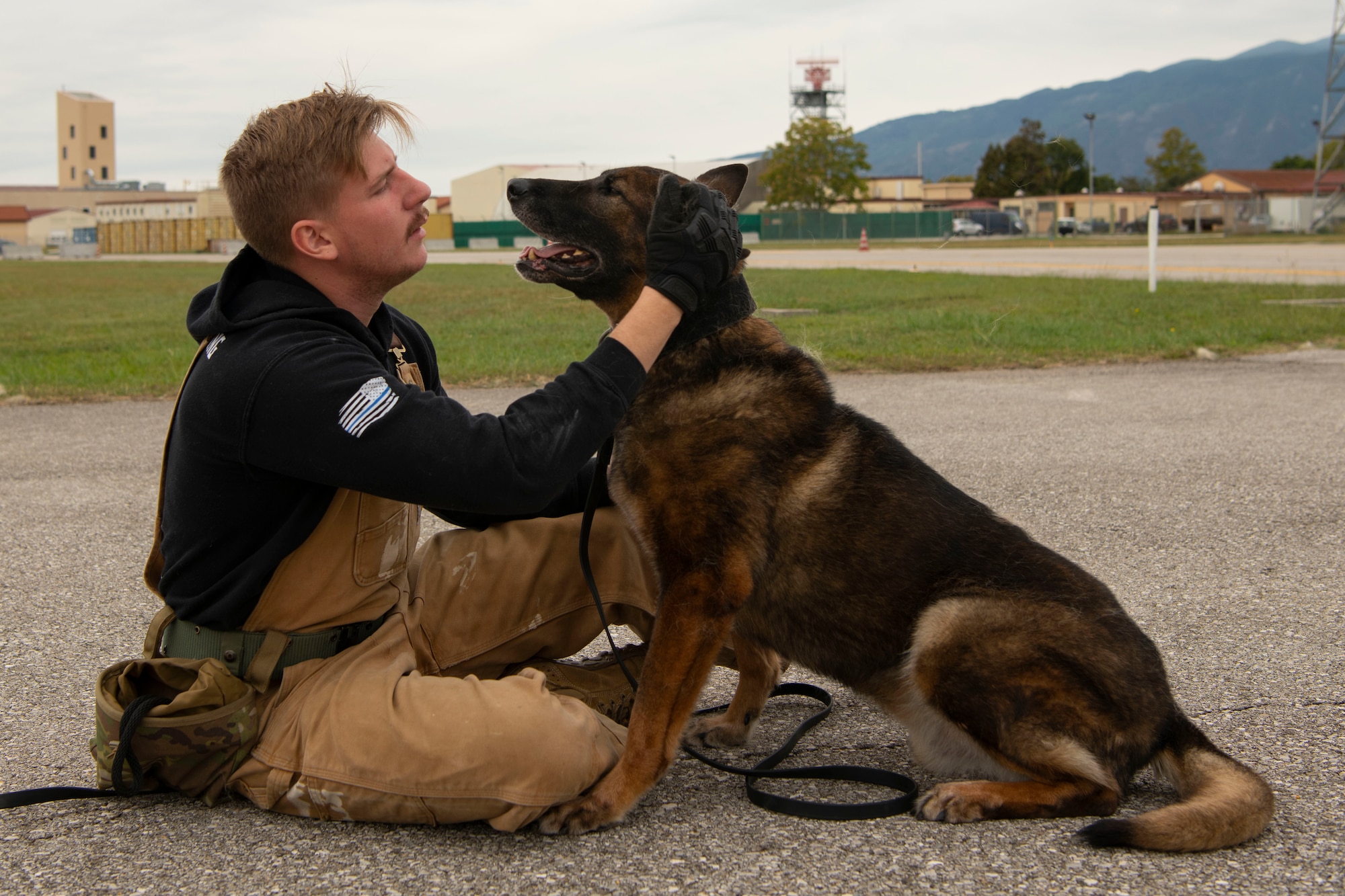 Kay, 31st Security Forces military working dog, and Senior Airman Ian Moran, 31st Security Forces military working dog handler, prepare before an explosive detection training at Aviano Air Base, Italy, Sept. 28, 2022. Similar to new Airmen, MWDs must receive initial training before the dogs can receive their explosive detection and patrolling training. (U.S. Air Force photo by Airman 1st Class Thomas Calopedis)