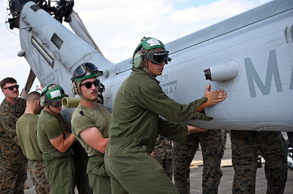 Marines with the Marine Light Attack Helicopter Squadron – 773, Det. Alpha guide a Bell AH-1Z Viper helicopter onto a C-5M Super Galaxy aircraft at Naval Air Station Joint Reserve Base New Orleans, Louisiana, Sept. 13, 2022. This was the first time the Marines from the HMLA-733 participated in the NATO days air show. (U.S. Air Force photo by Staff Sgt. Monet Villacorte)