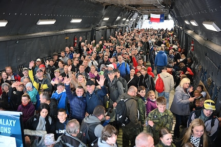 NATO Days air show participants smile and wave as they walk through a C-5M Super Galaxy aircraft in Ostrava, Czech Republic Sept. 17, 2022. The C-5M was the largest aircraft on display during the two-day event. (U.S. Air Force photo by Staff Sgt. Monet Villacorte)