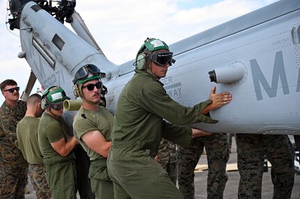 Marines with the Marine Light Attack Helicopter Squadron – 773, Det. Alpha guide a Bell AH-1Z Viper helicopter onto a C-5M Super Galaxy aircraft at Naval Air Station Joint Reserve Base New Orleans, Louisiana, Sept. 13, 2022. This was the first time the Marines from the HMLA-733 participated in the NATO days air show. (U.S. Air Force photo by Staff Sgt. Monet Villacorte)