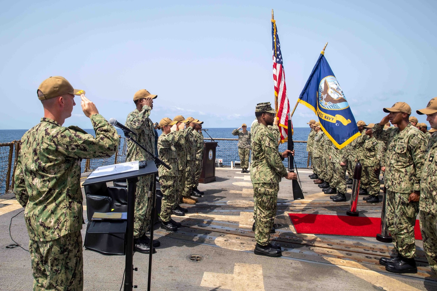 Sailors render honors during the national anthem during a change of command ceremony aboard the guided-missile destroyer USS Nitze (DDG 94) in the Gulf of Aden, Sept. 28. USS Nitze is deployed to the U.S. 5th Fleet area of operations to help ensure maritime security and stability in the Middle East region.