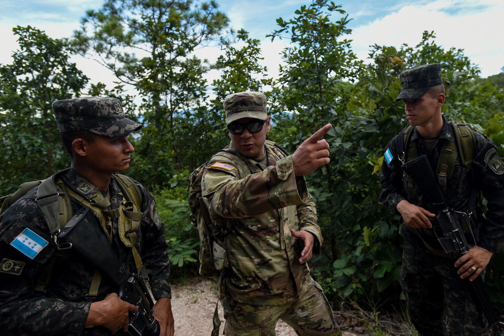 Sgt. Osvaldo Pina, a member of the Georgia National Guard's 1st Battalion of the 54th Security Force Assistance Brigade, discusses the route during a 15-mile ruck march alongside Honduran Army counterparts near Tegucigalpa, Honduras, Sept. 8, 2022. Pina and other SFAB members were participating as part of their advising mission at the Honduran Army's Noncommissioned Officer Academy during a six-month deployment to Honduras —the first National Guard deployment of its kind.