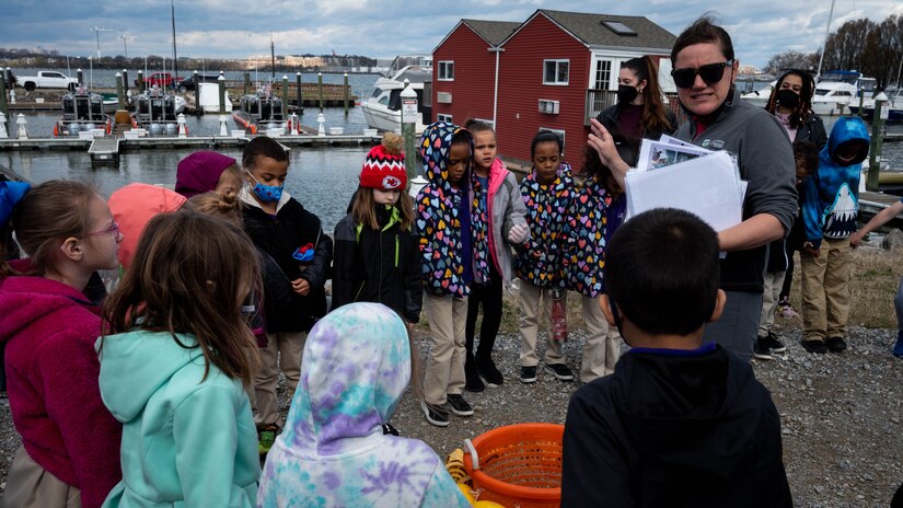Ariel Trahan, Anacostia Watershed Society director of river restoration programs, explains to LEARN D.C. students how the mussels are good for the environment and why they are good for cleaning the river during a mussel release event at Joint Base Anacostia-Bolling, Washington, D.C., April 1, 2022. The Anacostia Watershed Society came to JBAB to teach DC LEARN students about mussels and how they will be used to help clean the Anacostia River, while also conducting research on the best locations for mussels to live so they can clean the river. (U.S. Air Force photo by Staff Sgt. Stuart Bright)