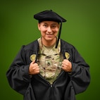 man in u.s. army uniform wearing a graduation gown.