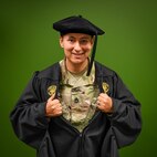 man in u.s. army uniform wearing a graduation gown.