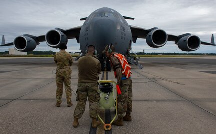 Airmen prepare to marshall an aircraft.