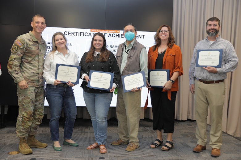 U.S. Army Corps of Engineers (USACE) Galveston District Commander Col. Rhett A. Blackmon (far left) awards the Matagorda Ship Channel Project Delivery Team with a group certificate of achievement during an award ceremony, September 29. 

(Starting second from left) Pictured are: Lisa Finn; Ashley Neil, Konstantinos Kostarelos; and Kari Gauntt. 

The team worked with the project's non-federal sponsor to design and provide oversight to improve navigation along the Matagorda Ship Channel.