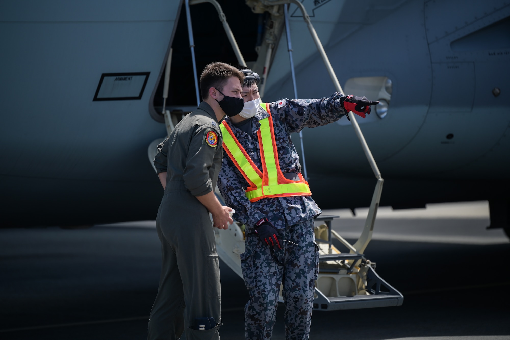 U.S. Air Force Capt. Zachary Morrow, 535th Airlift Squadron C-17 Globemaster III pilot, speaks to Japan Air Self-Defense Force 2nd Lt. Hayato Ogawa, 3rd Tactical Airlift Wing Maintenance and Supply Group Inspection Squadron 2nd platoon commander, during bilateral training at Joint Base Pearl Harbor-Hickam, Hawaii, Sept. 26, 2022. Four aircrew members from the 535th AS flew with JASDF aircrew on a Kawasaki C-2, learning their techniques and procedures. (U.S. Air Force photo by Staff Sgt. Alan Ricker)