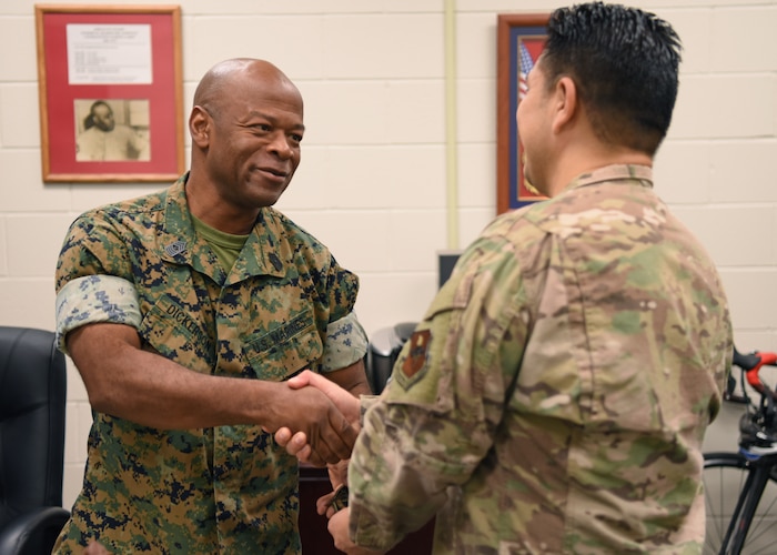 U.S. Air Force Maj. Jose Vallejo, 312th Training Squadron director of operations, presents Master Gunnery Sgt. Terrail Dickerson, Marine Corps Detachment Goodfellow Fire Protection senior enlisted leader, with a suicide awareness patch at the Louis F. Garland Department of Defense Fire Academy, Goodfellow Air Force Base, Texas, Sept. 8, 2022. The patch was initially distributed within the Air Force and then provided to members of the other service branches. (U.S. Air Force photo by Senior Airman Ethan Sherwood)