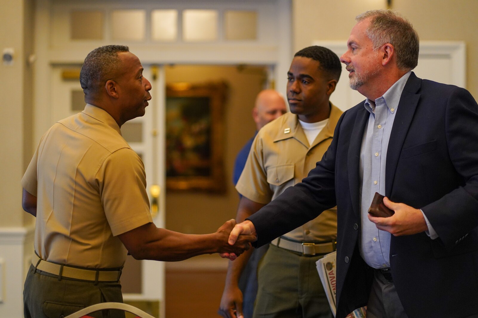 U.S. Marine Corps Col. Michael L. Brooks, left, base commander, Marine Corps Base Quantico, shakes hands with Bruce Potter, right, publisher of InsideNoVa, at the MCBQ media roundtable at The Clubs at Quantico and Crossroads Event Center on Marine Corps Base Quantico, Virginia, Sept. 28, 2022. The media roundtable allowed local journalists an opportunity to meet with Brooks, ask questions, and discuss MCBQ’s role and partnerships in the surrounding community. (U.S. Marine Corps photo by Cpl. Eric Huynh)