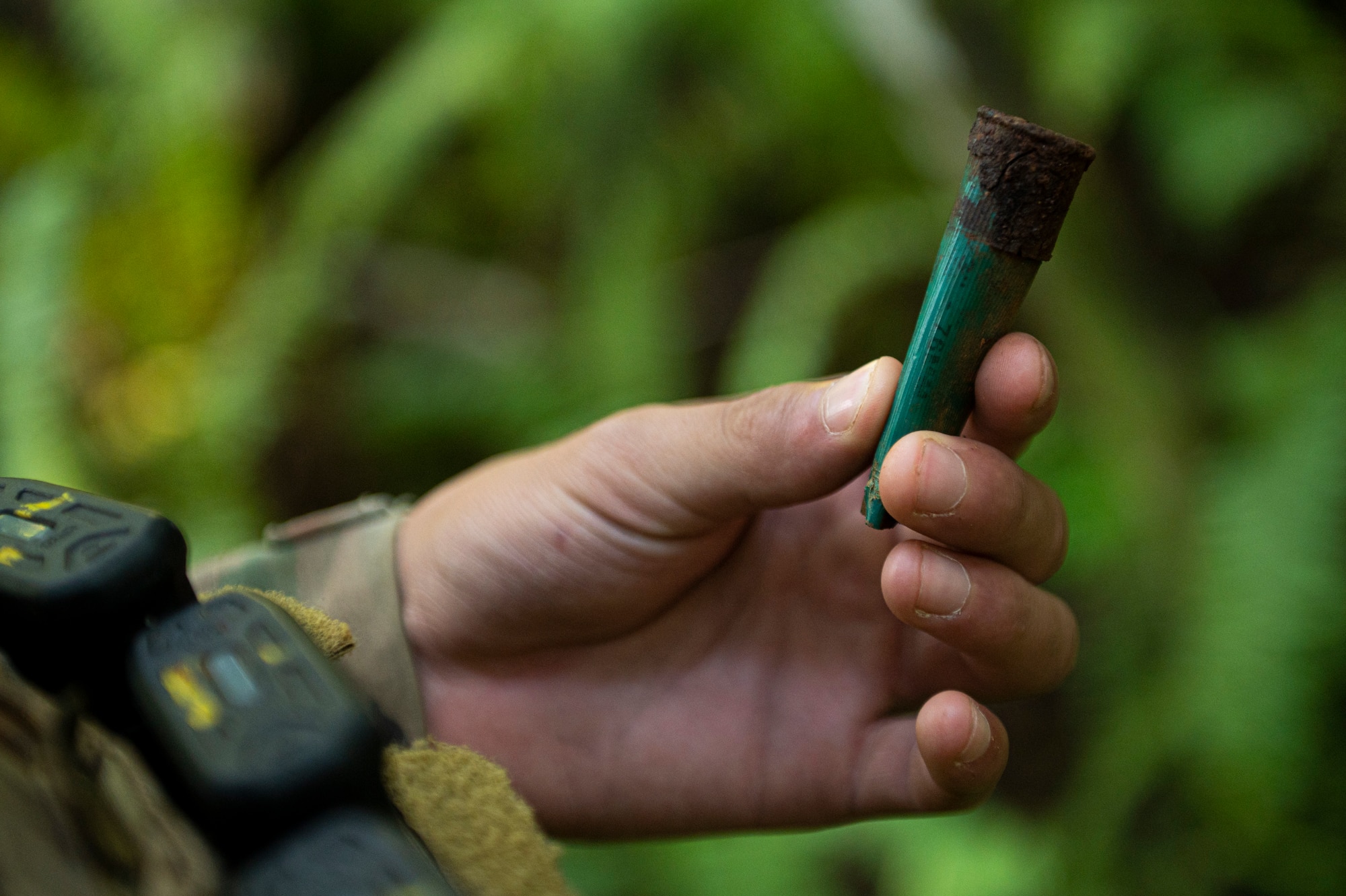 U.S. Air Force Airman 1st Class Jamerson Beverly, 36th Security Forces Squadron fire team leader, finds a discharged shotgun shell during a perimeter check on Andersen Air Force Base, Guam, Sep. 22, 2022. The Jungle Enforcement Team spends about eight hours a day patrolling the jungle looking for tracks, shotgun shells, dead carcasses, trash or people trespassing. (U.S. Air Force photo by Airman Spencer Perkins)