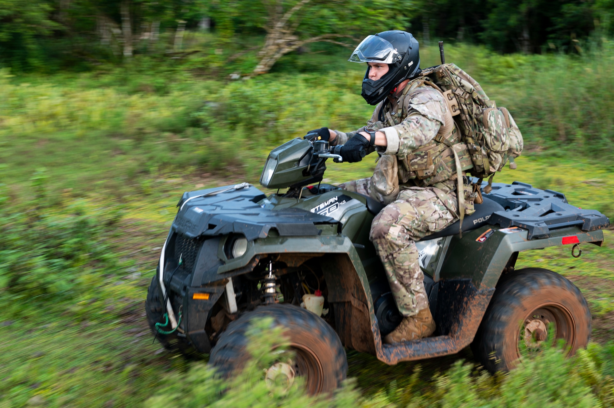 U.S. Air Force Senior Airman Dwayne Lopez, 36th Security Forces Squadron fire team leader, does performs an area check on an all-terrain vehicle on Andersen Air Force Base, Guam, Sep. 22, 2022. The Jungle Enforcement Team travels on ATVs because it allows them to go further and maneuver better through the jungle. (U.S. Air Force photo by Airman Spencer Perkins)